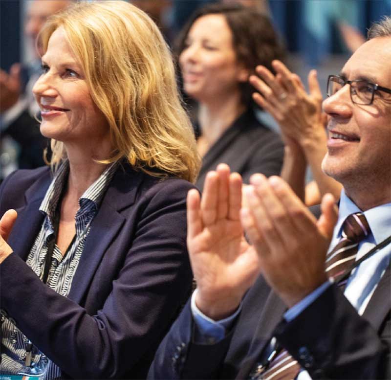 two business people clapping